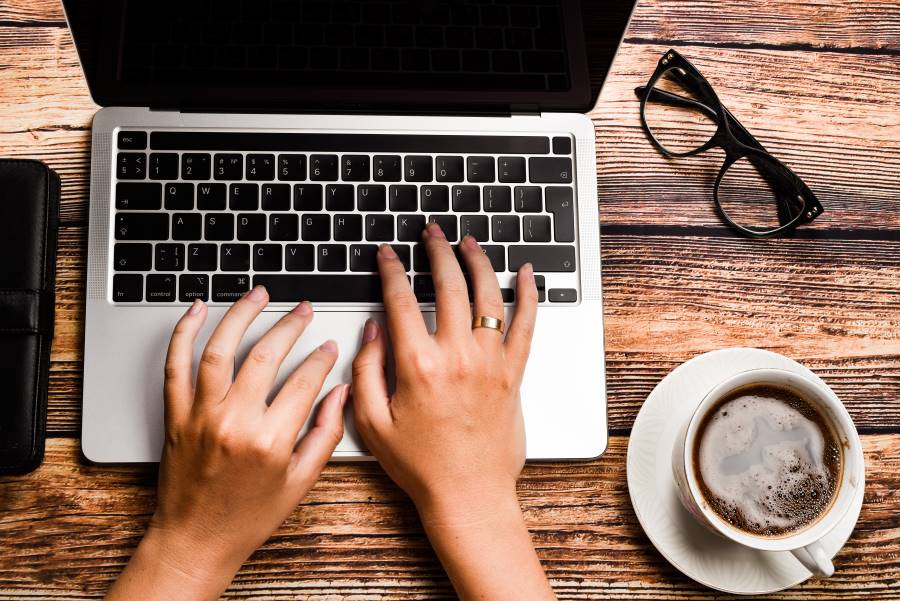 hands on the keys of a laptop computer